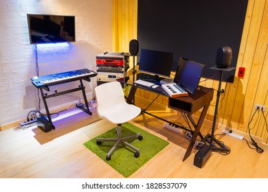 Home Recording Studio Showing Professional Audio Equipment In Small Modern Working Space, Wooden Wall And Floor