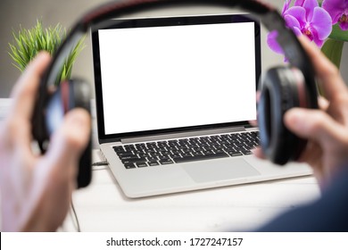 Home Relax Concept, A Man Listens To Music At Home. Laptop Computer White Blank Screen On Work Table. Copy Space, Home Office Workspace Concept, Laptop Mockup.