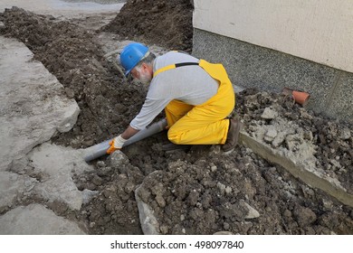 Home Renovation, Plumber Fixing Sewerage Pipe At Construction Site