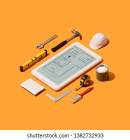 Home Renovation And Project Design App On A Touch Screen Tablet And Isometric DIY Construction Tools On A Smartphone