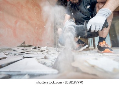 Home renovation project with man removing floor tiles - Shutterstock ID 2058197990