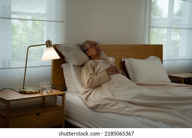 At Home Retirement Elderly Old Man Lonely Sick Laying Sleep On The Bed In Dark Bedroom 
