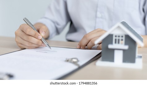 Home reviewer or real estate agent and sign a home purchase contract with home insurance promotion,Property insurance and security concept. - Shutterstock ID 1794881356