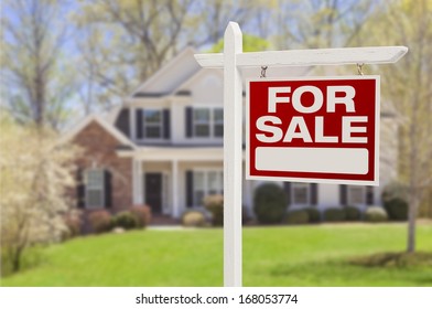Home For Sale Real Estate Sign in Front of Beautiful New House. - Shutterstock ID 168053774