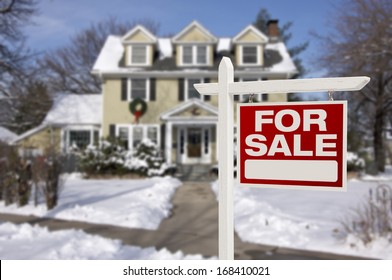 Home For Sale Real Estate Sign in Front of Beautiful New House in the Snow.