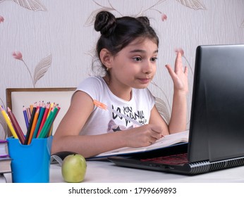 at home schoolgirl do homework, focused little Asia girl watch video lesson using laptop app, interested in on-line web virtual class studying from at home, homeschooling concept - Powered by Shutterstock