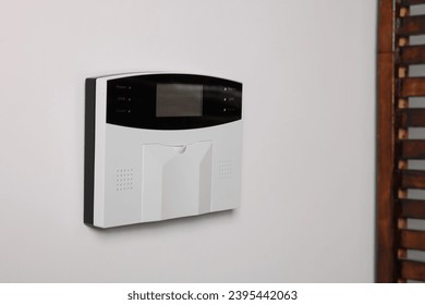 Home security alarm system on white wall indoors, space for text - Shutterstock ID 2395442063