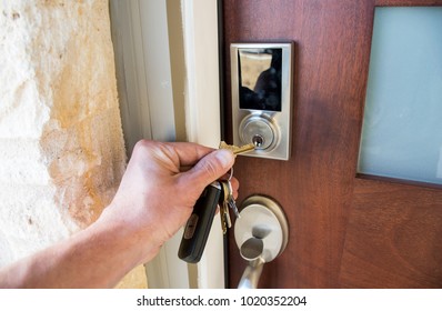 Home security is the front line of defense unlocking the door on your brand new brick home . Front door of nice new modern home in the suburbs of Austin Texas - Shutterstock ID 1020352204