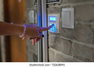 Home Security System. Woman Entering Password On Home Alarm Keypad