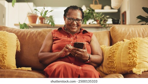 Home, senior woman and smartphone with typing, connection and chatting in living room. African person, apartment and lady with cellphone, mobile user and internet with message, social media and text - Powered by Shutterstock