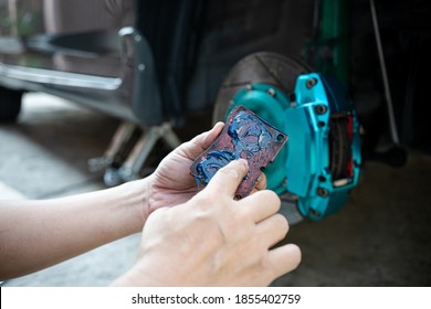 Home service car concept : Close up hand a man Hold brake pads and applying Grease anti seize on the back brake pads in car caliper brake and check system in basic maintenance 