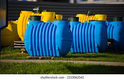 A Home Sewage Treatment Plant. Ready Set For Independent Assembly. Plastic Large Tanks In Blue And Yellow, Along With Pipes And Other Necessary Utensils.