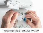 Home smoke and fire alarm detector man installing, maintenance, checking, testing or replace battery
