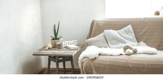 Home sofa with objects of cozy decor in the living room on a chair . The concept of decor and home atmosphere .