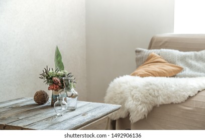 Home sofa with objects of cozy decor in the living room on a chair . The concept of decor and home atmosphere .