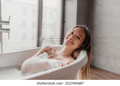 Home Spa, Hygiene, Relaxation Concept. Portrait Of Happy Woman Taking Bath At Home, Lying In Foamy Bathtub, Looking At Camera And Smiling, Copy Space