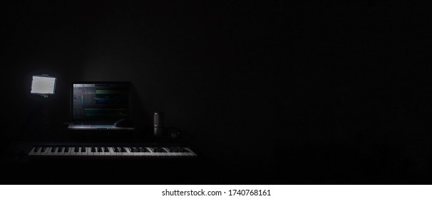 Home studio recording for audio mixing, sound design and music production with a empty space on a black background.