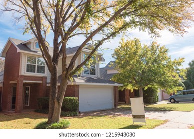 Home In Suburban Dallas-Fort Worth With Empty House For Sale By Owner Yard Sign. Colorful Autumn Fall Foliage In Texas, North America.