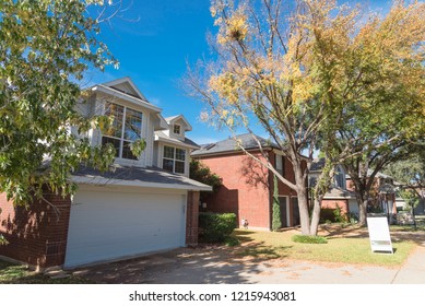 Home In Suburban Dallas-Fort Worth With Empty House For Sale By Owner Yard Sign. Colorful Autumn Fall Foliage In Texas, North America.