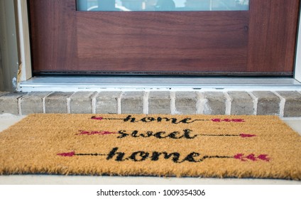 Home Sweet Home Doormat. Entrance To A New Luxury House With Solid Wood Front Door With Brick Front Step. Welcome To Home Ownership And Suburban Living In Suburbia In Austin , Texas , USA