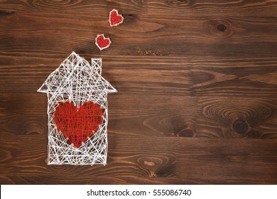 Home Sweet Home. Handmade Home Symbol With Heart Shape On Wooden Background With Copy Space