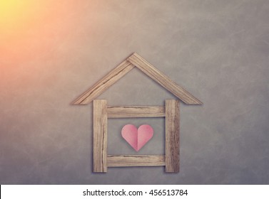 home sweet home house shape paper cut with red heart on grey background vintage color tone