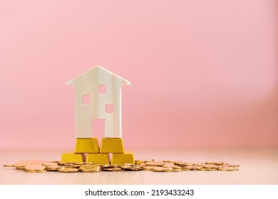 The Home Sweet Home Put On The Stack Gold Bar And Coin With Growing Value On The Pink Background In The Office, Loan For Real Estate Or Saving Money For Buy House To Family Concept.