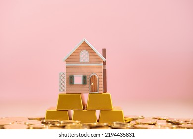 The Home Sweet Home Put On The Stack Gold Bar And Coin With Growing Value On The Pink Background In The Office, Loan For Real Estate Or Saving Money For Buy House To Family Concept.