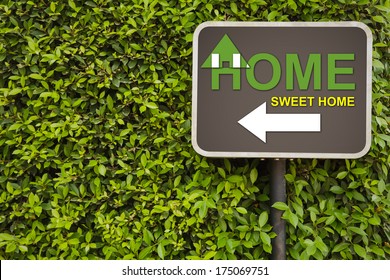 Home Sweet Home Sign On Green Leaves Wall