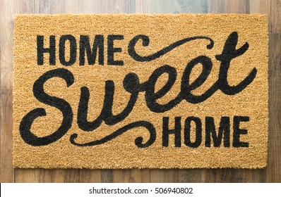 Home Sweet Home Welcome Mat On Wood Floor.