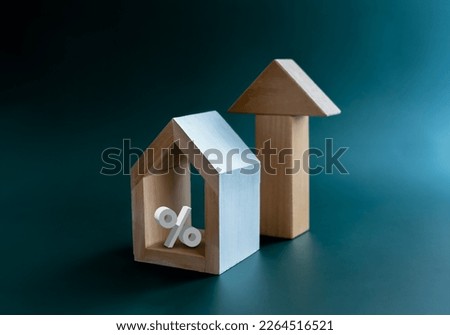 Home tax, Property refinance, house mortgage, financial, loan, investment housing real estate interest rates concepts. Percentage in minimal house with big rising arrow isolated on blue background.