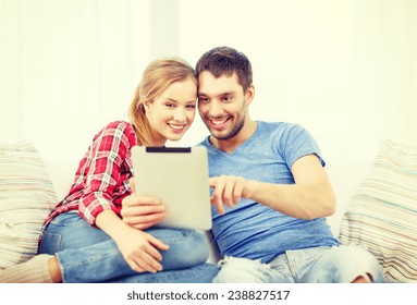 Home, Technology And Relationships Concept - Smiling Couple With Tablet Pc Computer At Home