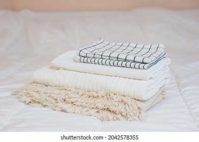 Home Textiles. A Stack Of Towels Lies On A White Bed