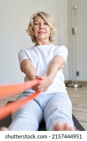 Home Training Concept. Strong Senior Woman Doing Exercises With Dumbbells Indoors. Cheerful Mature Lady Working Out Her Arm Muscles, Keeping Fit, Leading Healthy Lifestyle