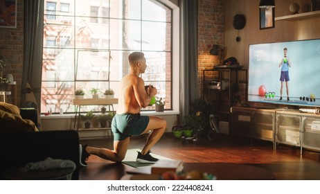 Home Training: Handsome Black Man Using Kettlebell Situps, Exercising with Personal Trainer via TV Online Video App. Mixed Race Sportsman Using Workout Service Fitness Streaming App for Virtual Gym. - Powered by Shutterstock