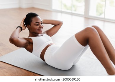 Home Training. Sporty Smiling African American Woman Exercising Doing Sit-Ups Abs Crunches Exercise Indoors Lying On Yoga Mat. Sport Workout Routine, Morning Physical Training Exercises Concept - Shutterstock ID 2000069180