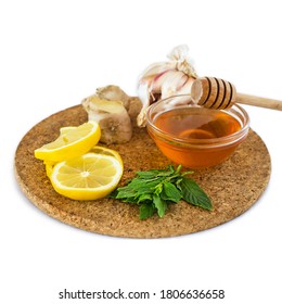 Home Treatment Kit For Flu And Seasonal Colds. Lemon, Mint, Honey, Ginger And Garlic On Wooden Tray Isolated On White Background