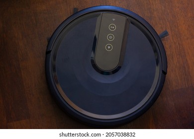 Home Use Auto Cleaning Robot Black Vacuum Cleaner On Floor. Smart Rechargeable Machine From Above