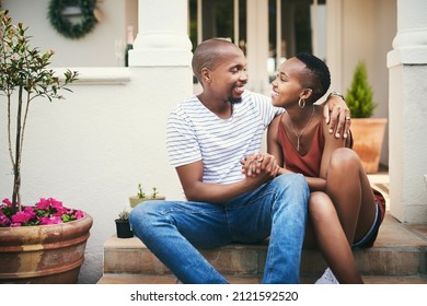 Home Is Wherever You Are, Babe. Shot Of An Affectionate Couple Sitting On Their Front Door Steps.