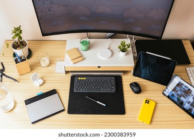 Home work desk for teleworking. Phone, tablets, headphones, monitor...