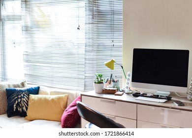 Home Working Area With Office Desk Set Up In Living Room