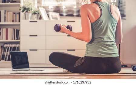 Home Workout Concept Woman In Living Room With  Laptop And Dumbells Mental Health In Quarantine