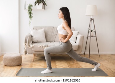 Home Workout. Girl Doing Aerobics Warming Up For Flexibility, Leg Stretching