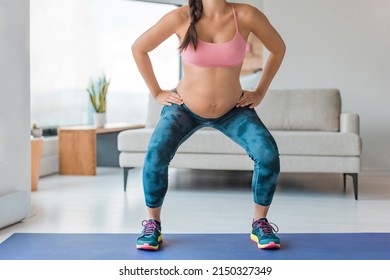 Home Workout Pregnant Woman Squatting Doing Leg Workout Squat With Fitness Online Class Standing On Yoga Mat. Pregnancy Prenatal Exercise.