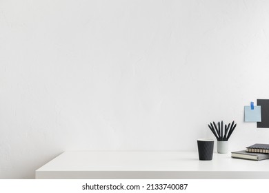 Home workspace, creative desk with wooden supplies and blue wall. - Shutterstock ID 2133740087