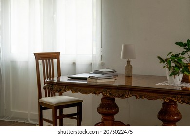 Home workspace design, interior living room workspace with antique table, personal computer and books