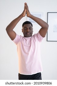 Home Yoga. Calm Black Man. Peace Balance. Harmony Mind. Tranquil African Guy Meditating Practicing Tree Pose Hands Under Head Light Room Interior.