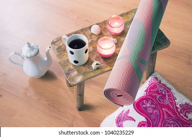 Home Yoga Setup With Tea, Candles, Pillow, Yoga Mat And Natural Shells. Zen Accessories For Meditation And Relaxation At Home. Top View Of The Floor With No People.