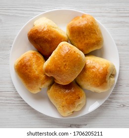 Home-baked Beef Russian Bierocks On A White Plate On A White Wooden Table, Top View. Flat Lay, Overhead, From Above. 