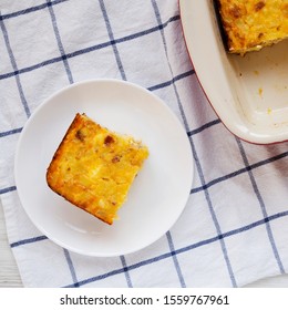 Home-baked Cheesy Amish Breakfast Casserole On A White Plate, Top View. Flat Lay, Overhead, From Above. Close-up.